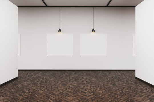 Two pictures in a dark wood floor art gallery