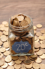 A bottle filled with twenty cents South African coins