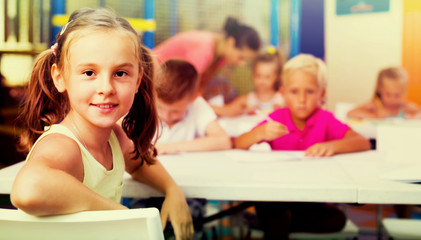 little school girl in class .