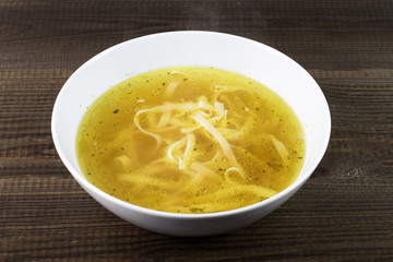 Chicken broth with noodles. Traditional polish soup.