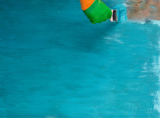 aquamarine colored wooden surface, paint brush, fresh paint