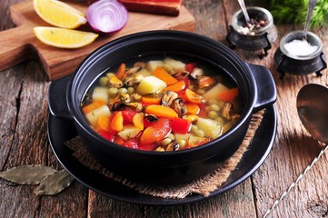 Fish soup with wild mussels, potatoes, carrots, tomatoes, pepper and dill.