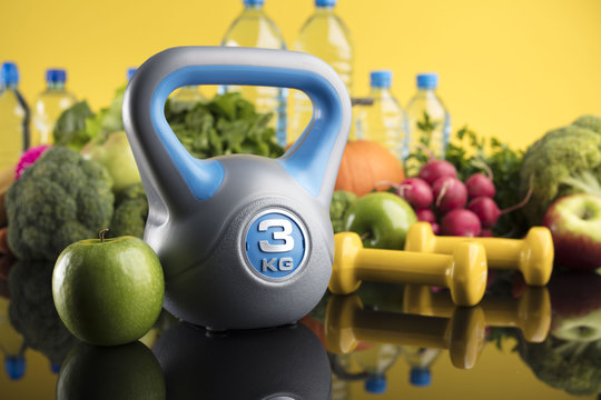 Diet and Fitness theme with healthy food. Place for typography and logo. Beautiful reflections. Bright blue background. Lots of vegetables, fruits and fitness equipment. Healthy lifestyle concept.