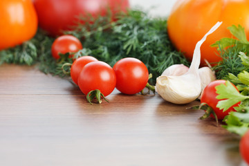 Fresh ripe vegetables on wooden table background