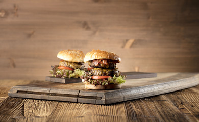 Fresh home-made hamburger served on wood, place for typography