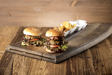 Fresh home-made hamburger served on wood, place for typography