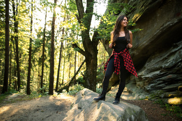 Active healthy woman hiking in beautiful forest.