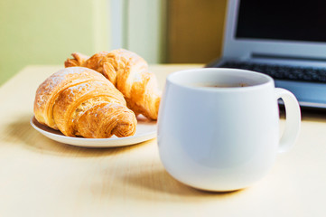Working time, coffee break with croissant