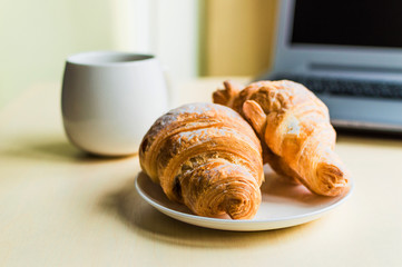 Working time, coffee break with croissant