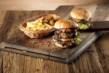 Fresh home-made hamburger served on wood, place for typography