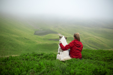 Stock Photo: Female hiker and her dog on a mountain top. Happy smiling woman hiking with dog, Recreation and healthy lifestyle outdoors in mountains.Beautiful inspirational landscape, trekking and act