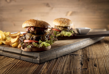 Fresh home-made hamburger served on wood, place for typography