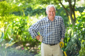 Senior man with equipment in garden