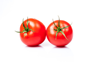 Two tomatoes isolated on a white background
