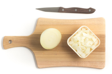 Diced Onions. Onions in cubes over a wooden board
