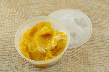 Frozen acorn squash leftovers thawing in plastic container