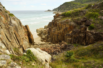 Fototapeta na wymiar Rocky coastline and a tiny beach near South West Rocks, New South Wales, Australia.