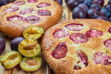 Home made plum buns on a wooden table
