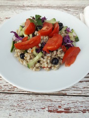 Vegetarian salad of boiled barley with vegetables