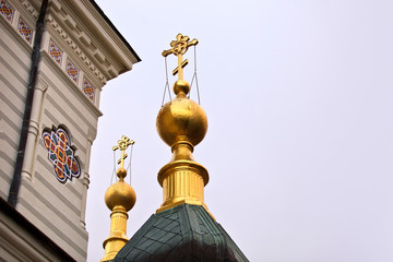 Dome of the church and a gold cross close up