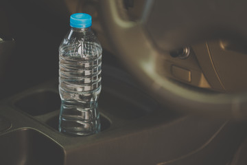 image concept Bottled water was left in the car for a long time. To drink it?