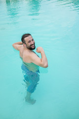 Young boy kid child splashing in swimming pool having fun leisur