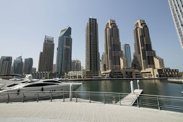 Fototapeta na wymiar Architecture theme. Dubai, marina bay at noon. Luxurious travel and living.. Business and finance concept. Futuristic architecture. Luxury apartments. High value properties.