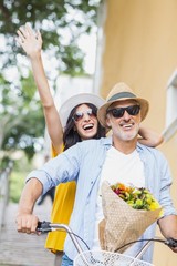 Excited couple cycling outdoors