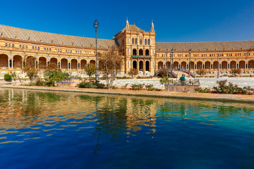 Spain Square or Plaza de Espana in Seville in the sunny summer day, Andalusia, Spain. Flower beds,...