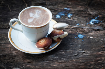 A cup of coffee with milk on a wooden background