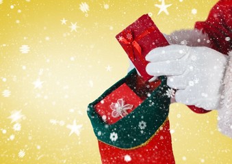 Santa putting gifts in christmas stocking