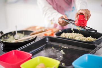 Muslim Arabic traditional woman in kitchen preparing food for lu
