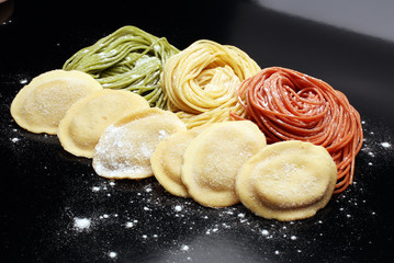 Fettuccine and spaghetti with ingredients for cooking pasta on a white background, top view. Flat lay