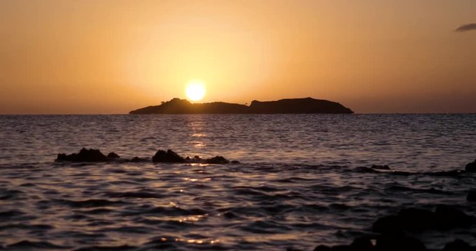 Beautiful Sunrise View at the Sea With Silhouette of an Island on the Horizon