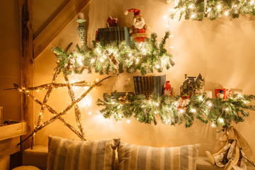 Calm image of interior modern home living room decorated christmas tree and gifts, sofa, table covered with blanket.