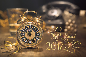 Vintage alarm clock showing five to twelve. Happy New Year 2017!