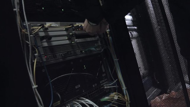 Worker Connect the Equipment Into Server Rack