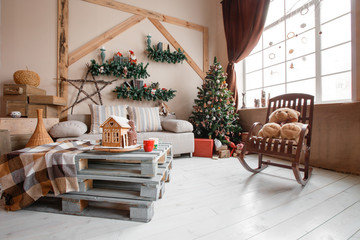 Calm image of interior modern home living room decorated christmas tree and gifts, sofa, table covered with blanket.