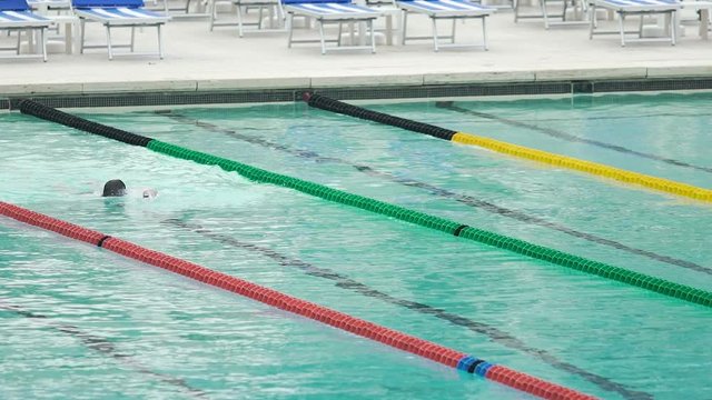 Athlete swimming crawl stroke in pool, training before competition, water sports