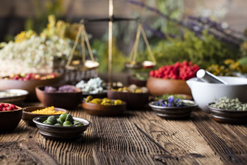 Assorted natural medical herbs and mortar