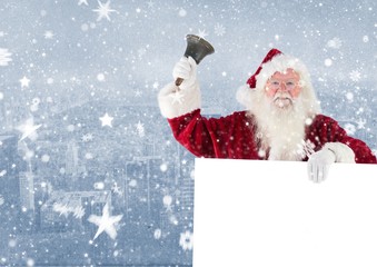 Santa claus holding a blank placard and bell