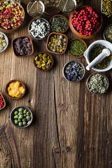 Assorted natural medical herbs and mortar