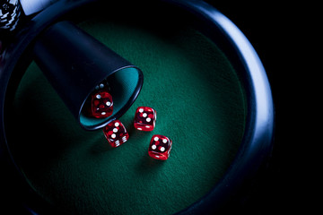 Casino theme. High contrast image of casino roulette, poker game, dice game, poker chips on a...