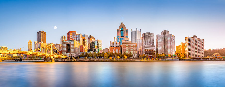 Long exposure of Pittsburgh downtown skyline and Roberto Clemente bridge, on a sunny afternoon, as viewed from North Shore Riverfront Park, across Allegheny River.