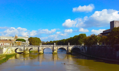 View of the bridge, the river Tiber, Bernini's statue on the bridge, Rome, Italy.