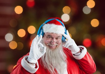 Cheerful Santa claus wearing headphones