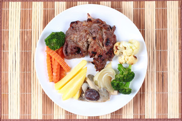 Home made ,Pork steak and mixed vegetables served.