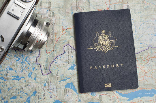 Close up of an Australian passport with map and retro camera