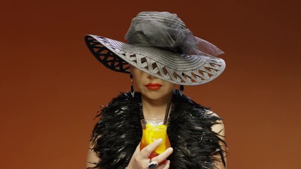 Glamour woman in big elegant hat with coctail . Shot on RED EPIC Cinema Camera. - Powered by Adobe