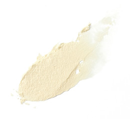 Pearl color make up cream in abstract shape on background